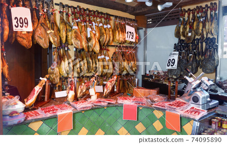 Assortment of traditional Spanish meat shop with dangling legs jamon 74095890