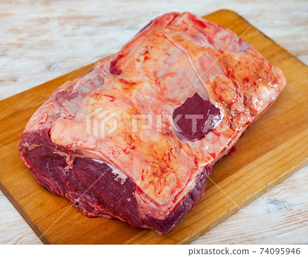 Closeup of beef tenderloin on cutting board 74095946