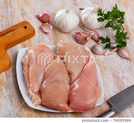 Raw chicken breast fillet with garlic and greens 74095999