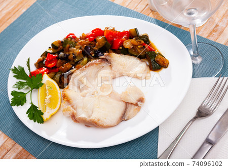 Fried steak of blue shark with baked vegetables and lemon 74096102