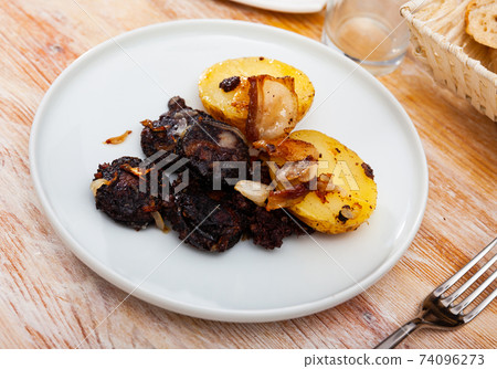 Fried rustic tasty blood sausage with potato served at plate Fried rustic tasty blood sausage with potato served at plate 74096273