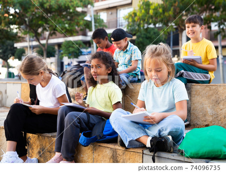 Group of kids having open air lesson Group of kids having open air lesson 74096735