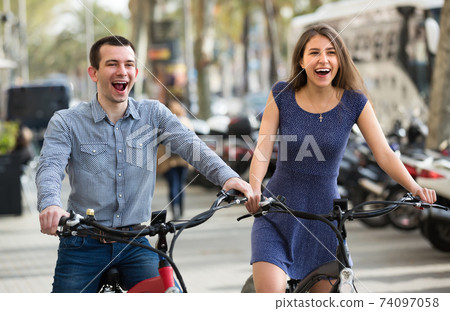 Young couple with electric bikes . 74097058