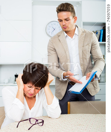 Mother and son sign documents 74097059