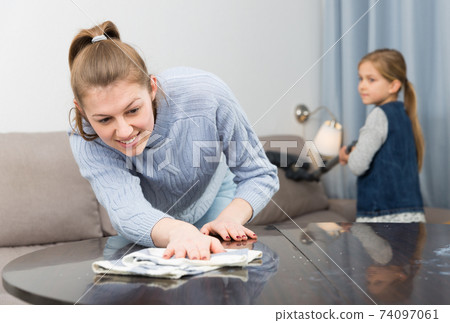 Woman with daughter cleaning house Woman with daughter cleaning house 74097061