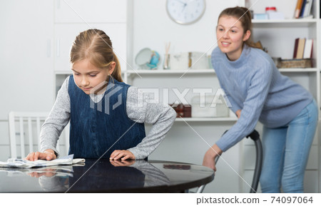 Woman with daughter cleaning house Woman with daughter cleaning house 74097064