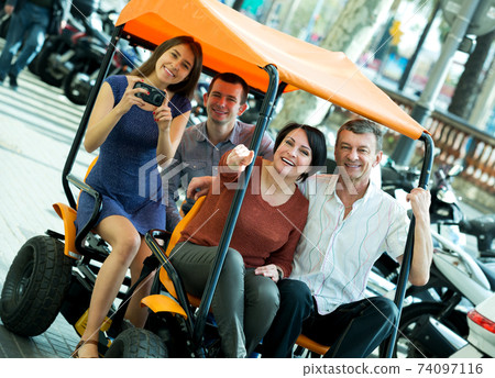 Family of four sitting in grand tour electric Family of four sitting in grand tour electric 74097116