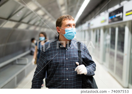 Man in medical mask on subway platform 74097553