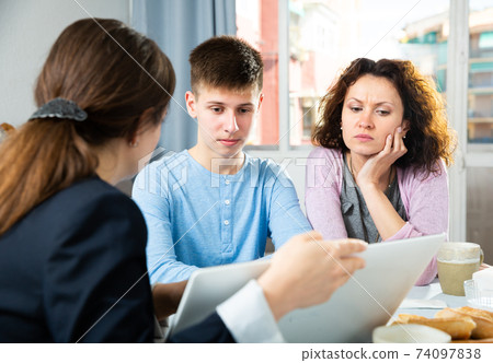 Woman with son meeting with tutor 74097838