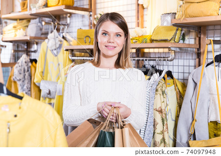 Woman carrying paper bags with purchases in fashion store 74097948