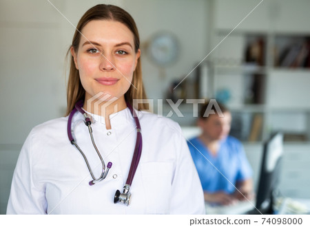 Smiling female doctor in medical office 74098000