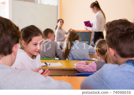 Pupils chattering at lesson Pupils chattering at lesson 74098038