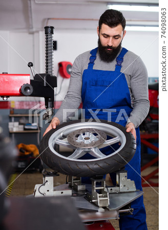 Worker repairing wheel Worker repairing wheel 74098063