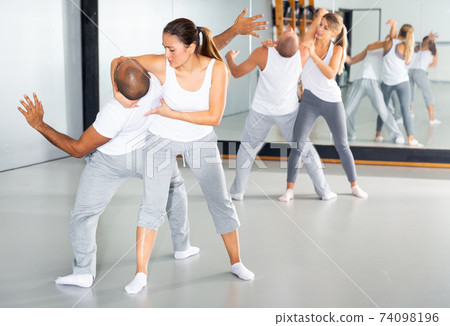 Woman doing strength techniques in self defense training Woman doing strength techniques in self defense training 74098196