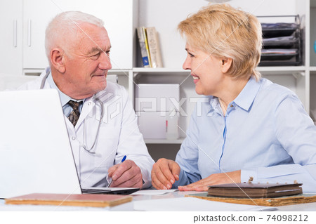 Male doctor with female client Male doctor with female client 74098212