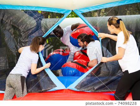 African American man boxing on inflatable ring 74098228
