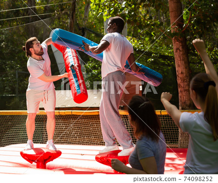 Cheerful men having fun on gladiator fight arena Cheerful men having fun on gladiator fight arena 74098252