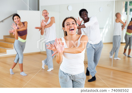 Young woman dancing at group dance class Young woman dancing at group dance class 74098502