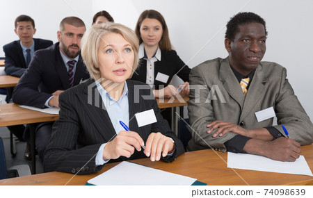 People during business seminar in lecture hall People during business seminar in lecture hall 74098639