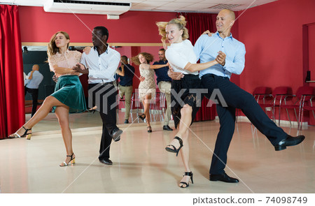 People dancing rock-and-roll in pairs People dancing rock-and-roll in pairs 74098749