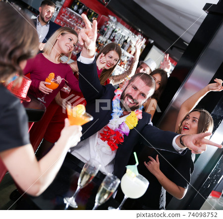 Man having fun on Hawaiian party at nightclub 74098752