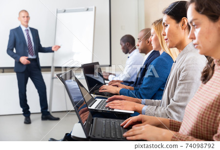 international group of managers with laptop in advanced training courses 74098792