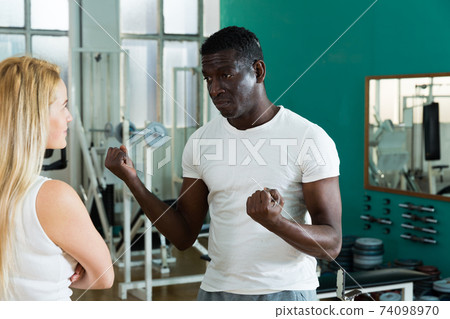 Man and woman talking at gym Man and woman talking at gym 74098970