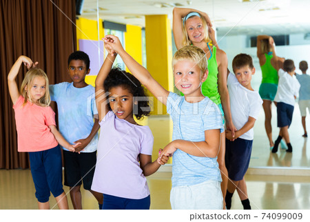 Little boys and girls dancing pair dance in the ballet studio Little boys and girls dancing pair dance in the ballet studio 74099009