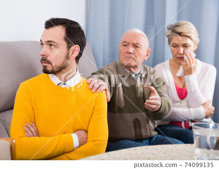 Parents arguing with son 74099135