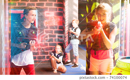 Teen kids during lasertag game 74100074