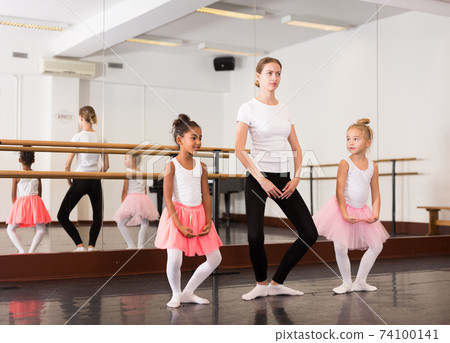 Ballet teacher and two little girls Ballet teacher and two little girls 74100141