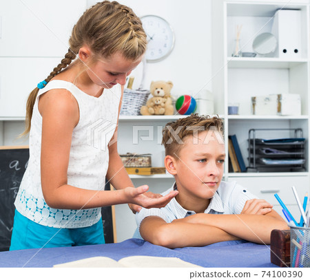 Girl is apologizing to a friend for bad behavior Girl is apologizing to a friend for bad behavior 74100390