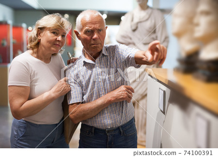 Man and woman visiting museum Man and woman visiting museum 74100391