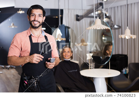 Portrait of sexy male professional hairdresser Portrait of sexy male professional hairdresser 74100823
