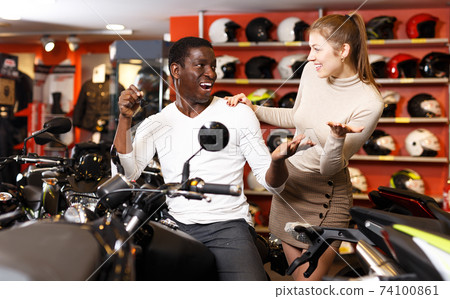 Couple posing on purchased motorcycle Couple posing on purchased motorcycle 74100861