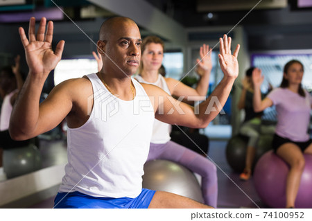 Young man doing exercises with fitness ball 74100952
