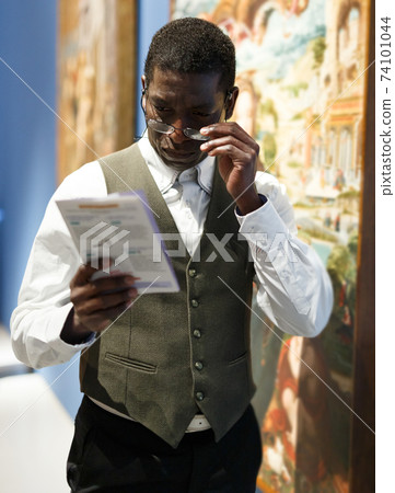 Man reading brochure about exhibits Man reading brochure about exhibits 74101044