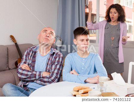 Woman scolding son and husband Woman scolding son and husband 74101122