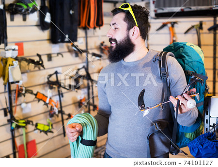 Man choosing climbing equipment Man choosing climbing equipment 74101127