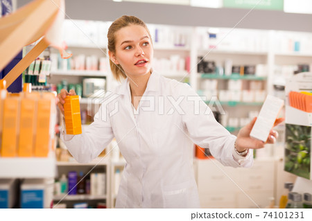 Female pharmacist help in choosing at counter 74101231