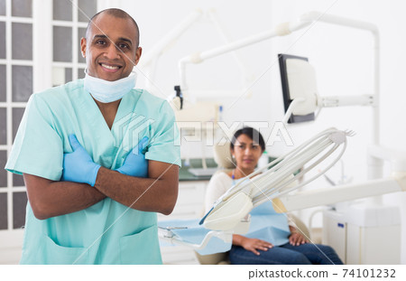 Successful professional dentist standing in modern dental office 74101232