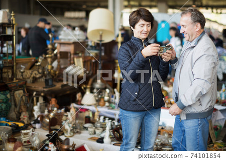 Loving mature family couple choosing vintage things Loving mature family couple choosing vintage things 74101854