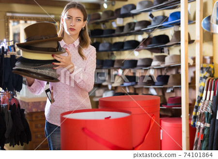 Saleswoman preparing hats in boxes for sale Saleswoman preparing hats in boxes for sale 74101864