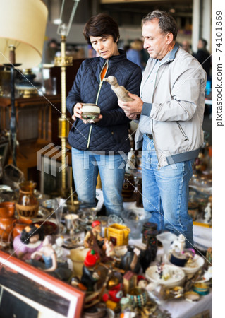 Couple shopping at flea market Couple shopping at flea market 74101869