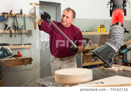 Master measures the wooden workpiece before machining Master measures the wooden workpiece before machining 74102116