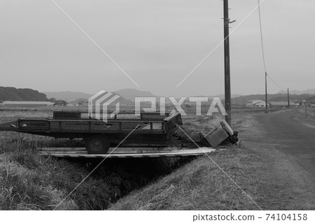 Agricultural equipment waiting for spring and slag heap monochrome 74104158