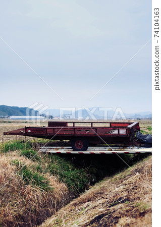 Agricultural equipment and slag heap waiting for spring 74104163