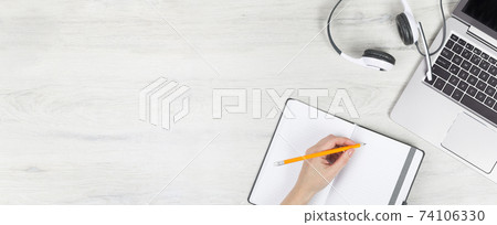 Laptop with headphones on white desk Laptop with headphones on white desk 74106330