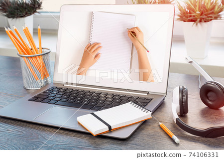 Laptop with headphones on adesk Laptop with headphones on adesk 74106331