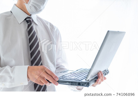 Senior businessman who can't work without a computer Senior businessman who can't work without a computer 74106896